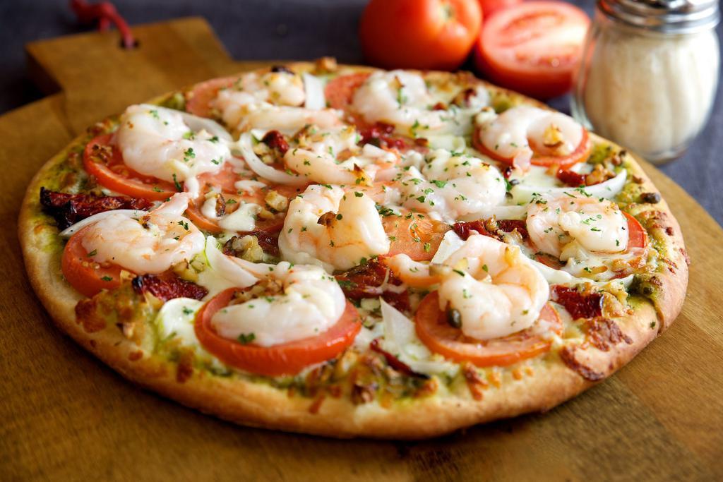 Pesto Lover's Gourmet Pizza · Shrimp, sun-dried tomato, roasted garlic, onions, tomato, parsley, and mozzarella cheese over pesto sauce. Contains nuts.