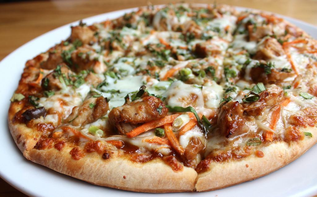 Thai Pie Gourmet Pizza · Grilled chicken, carrots, scallions, fresh cilantro, roasted peanuts, and mozzarella cheese over Thai peanut sauce. Contains nuts.