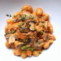 Gnocchi alla Vodka · Potato pasta, mushrooms and green peas simmered in homemade tomato-vodka cream sauce.