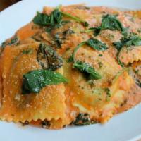 Spinach Ravioli · Ficotta-spinach ravioli sauteed with spinach and four-cheese sauce.