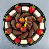 Ultimate Dipped Fruit™ Platter · This decadent dessert features fresh banana bites dipped in white and semisweet chocolate, s...