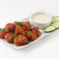 Thai Chicken Bites · Sweet and spicy boneless fried chicken tossed with a tangy Thai chili glaze. Served with but...