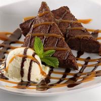 Dulce de Leche Brownie Sundae · A rich fudge brownie topped with vanilla ice cream and a rich dulce de leche caramel combina...