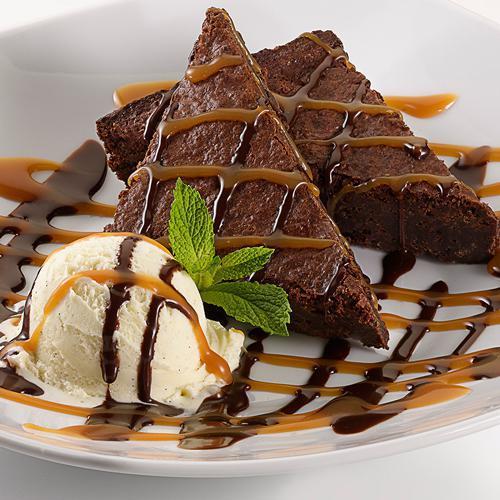 Dulce de Leche Brownie Sundae · A rich fudge brownie topped with vanilla ice cream and a rich dulce de leche caramel combination.