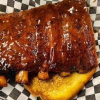 1/2 Rack Pork Spare Ribs · 5 to 6 bones generously seasoned and glazed in our signature house BBQ Sauce.