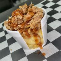 Piggy Mac · Our signature green chile mac and cheese topped with pulled pork and our house BBQ Sauce.