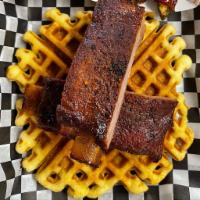 Ribs and Waffles · 1/2 Rack Spare Ribs served over a cornbread waffle with a side of honey butter.