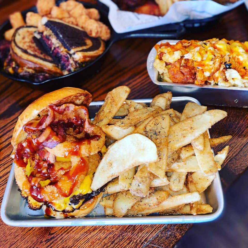 Saloon Burger w/ seasoned house fries and a pickle · our fresh burger with melted cheddar cheese , 2 onion rings, juicy bacon, and kickin bourbon sauce