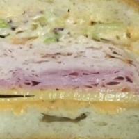 All American Sandwich · Turkey breast and ham, swiss cheese, coleslaw, Russian dressing on a roll.