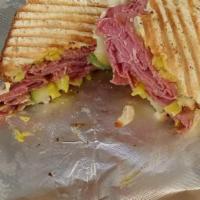Pastrami Sandwich · Lean pastrami, caramelized onion with Swiss cheese, pickles and brown mustard.