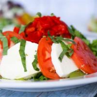 Caprese Salad · Fresh mozzarella cheese, tomatoes, olive oil and basil.