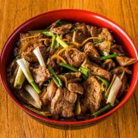 Mongolian Beef · stir-fry beef with Green onion and Yellow onion served on top of rice 