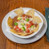 Bean Dip · Re-fried beans topped with cheese and tomatoes. Vegetarian.