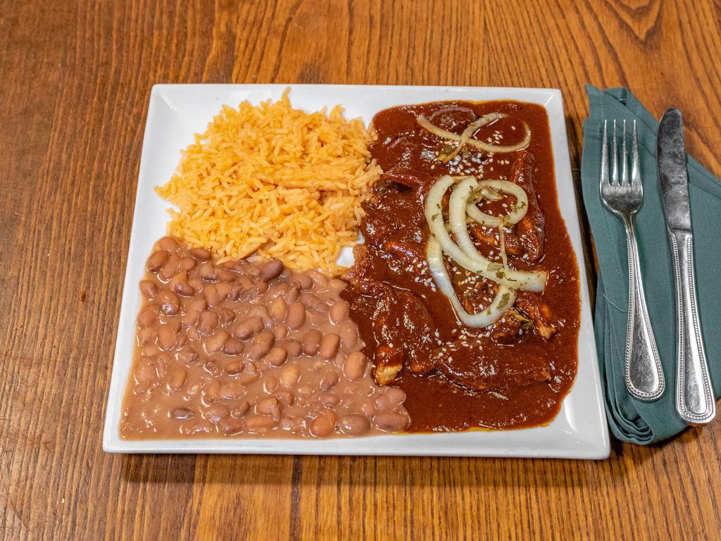 Chicken Mole Poblano · Bread, chocolate and various peppers in our special mole sauce that is served over grilled chicken breast. Topped off with sesame seeds and marinated onions. Choice of corn or flour tortillas.