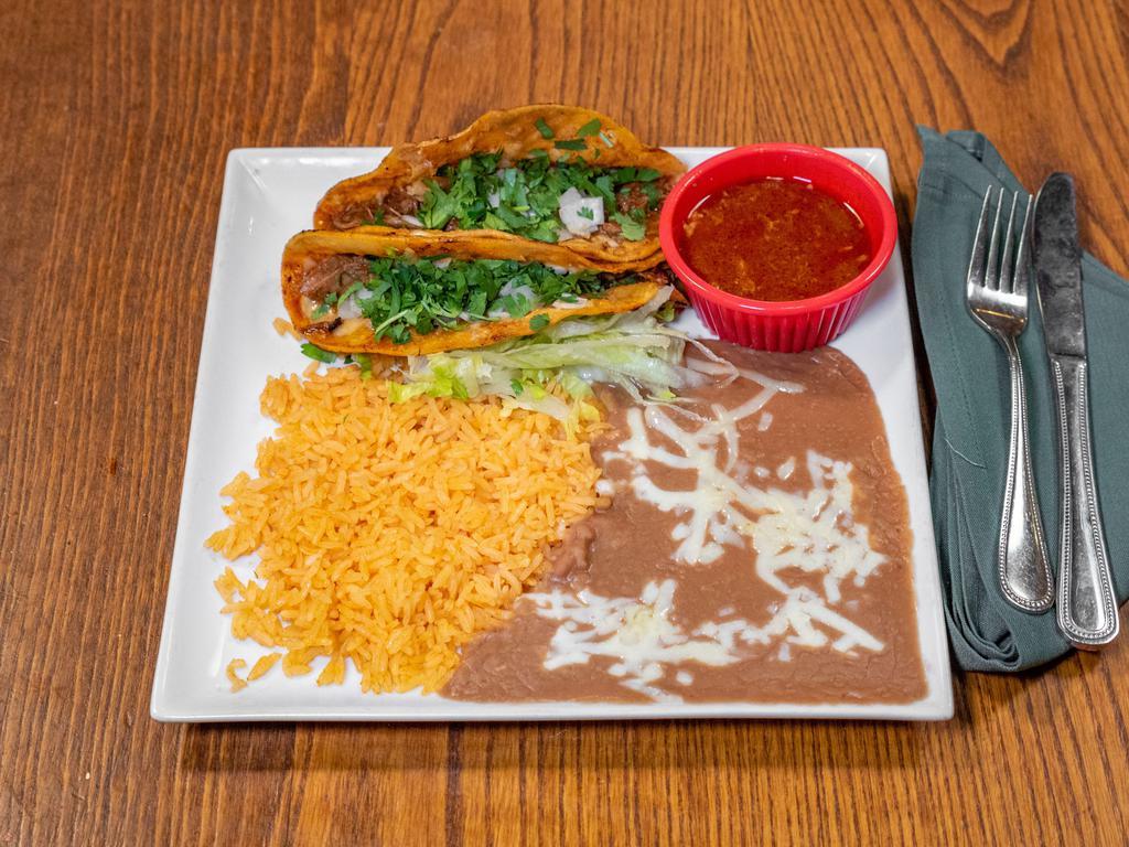 Quesabirria Tacos · 2 tacos stuffed with birria, onion, cilantro and cheese. Served with delicious side of con some dipping sauce.