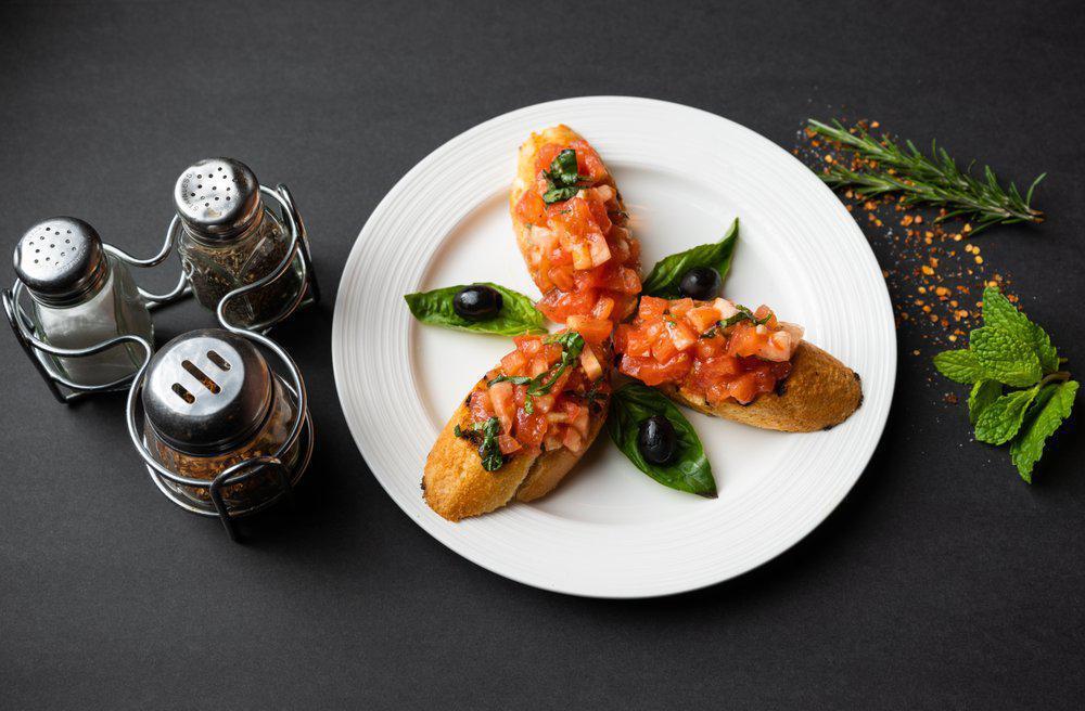 Bruschetta Al Pomodoro · Toasted garlic bread topped with fresh tomatoes, basil, garlic and extra virgin olive oil.