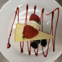 New York Cheesecake slice · New York Cheesecake slice with berry dressing and whipped cream