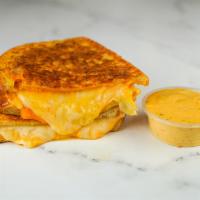 Three Cheese Monte Cristo · Cheddar, Swiss, and Parmesan cheese melted between egg dipped, griddled sourdough bread. Ser...