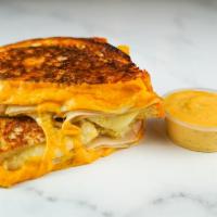 Roasted Turkey & Cheese Monte Cristo · Roasted turkey breast, Cheddar, Swiss, and Parmesan cheese melted between egg dipped, griddl...
