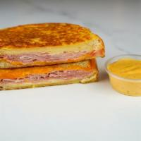 Smoked Ham & Cheese Monte Cristo · Smoked ham, Cheddar, Swiss, and Parmesan cheese melted between egg dipped, griddled sourdoug...