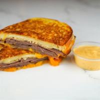 Roast Beef & Cheese Monte Cristo · Roast beef, Cheddar, Swiss, and Parmesan cheese melted between egg dipped, griddled sourdoug...