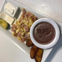 Huevos con Jamon · Scrambled eggs and ham. Served with avocado, fried plantains, fried beans, cream, with choic...