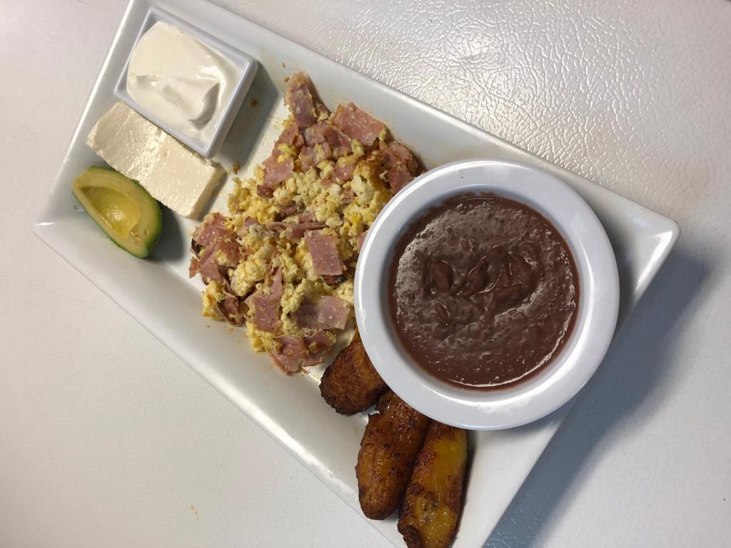 Huevos con Jamon · Scrambled eggs and ham. Served with avocado, fried plantains, fried beans, cream, with choice of homemade tortillas or flour tortillas.