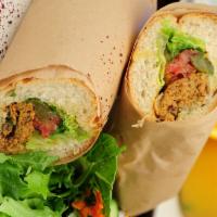 Koobideh Sandwich · Grilled ground beef or lamb, lettuce, tomato and pickles.