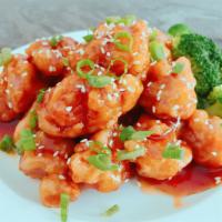 S12. Sesame Chicken · Fried sliced of white meat chicken cooked with special sauce topped with sesame seeds on a b...
