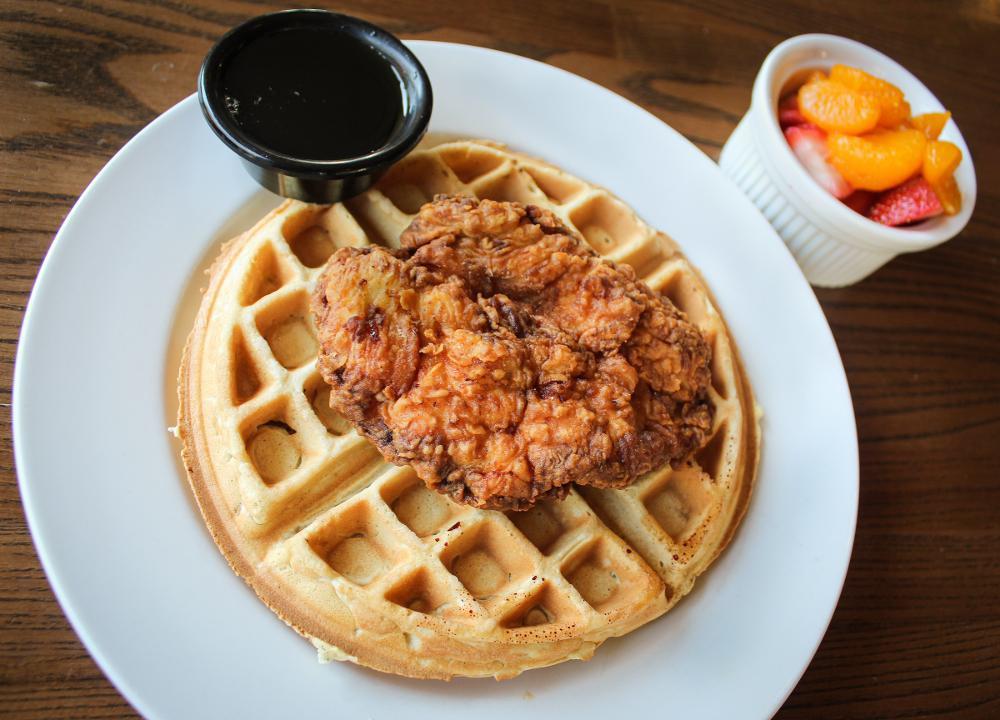 Chicken & Waffles · Hand-breaded boneless chicken breast, fried golden, and served over a Belgian waffle with real maple syrup and fresh fruit.