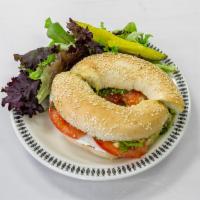 Revolution Bagel · Bagel of your choice topped with our amazing basil pesto, cream cheese, avocado, and fresh t...