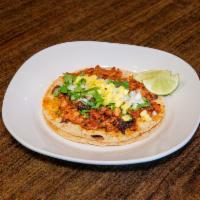 Taco al Pastor · Seasoned pork. Served with onion and cilantro. Extra topping extra charge