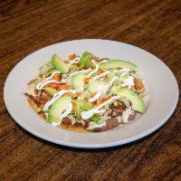 Huarache · Handmade tortilla. Served with beans, cheese, lettuce, tomatoes, avocado, cream and choice o...