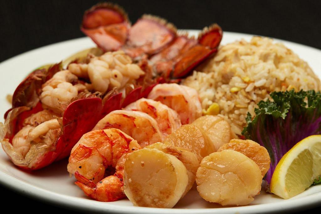 LOBSTER, SCALLOPS, & COLOSSAL SHRIMP  · Grilled cold water lobster tail with grilled scallops and colossal shrimp. Served with hibachi vegetables, “RA”ckin’ Fried Rice and homemade dipping sauces.