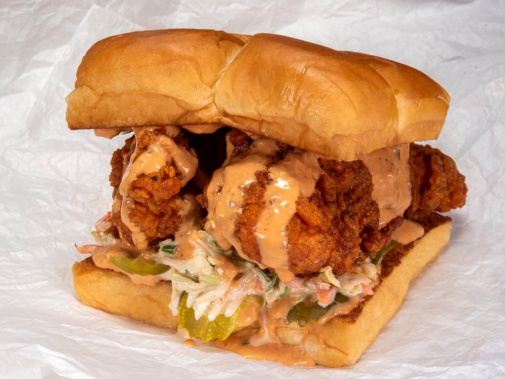 The Hot Chick · Two crispy fried chicken tenders, spiced to your liking, Plain, Nashville Hot or Nashville Hotter with secret sauce, dill pickle slices and slaw; served on Kings Hawaiian rolls