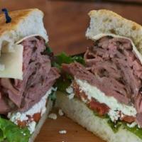 The Carver Sandwich · Roast sirloin, slowly cooked thinly sliced, and layered with aged white cheddar cheese, crum...