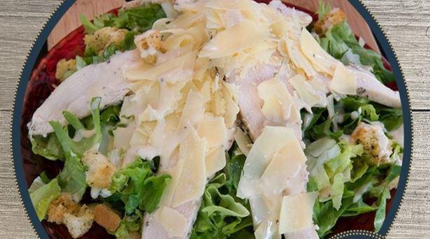 Caesar Salad · Romaine lettuce, shaved Parmesan cheese, croutons, and our Caesar dressing.
