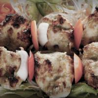 Mediterranean Chicken Kabob · Grilled pieces of chicken served with rice, hummus, and hot pita bread.