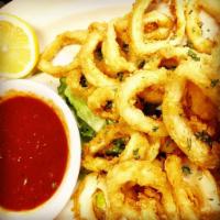 Fried Calamari · Calamari rings, battered and fried to a golden brown perfection and served with lemon and ma...