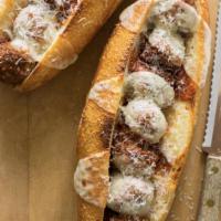 Meatball Parmigiana Sandwich · Breaded and fried then baked with mozzarella cheese and marinara sauce on a toasted baguette. 