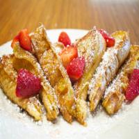 Strawberry French Toast · Our old fashioned French toast topped with strawberries and whipped cream.