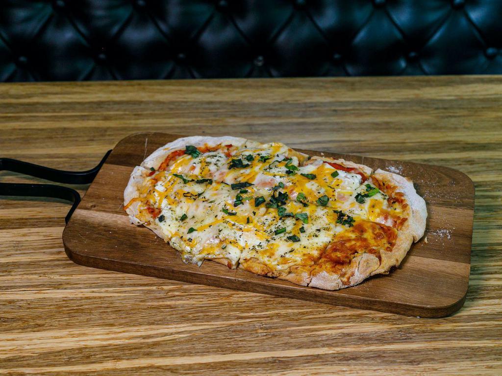 Cheese Flatbread · Oven Baked Flatbread, House Made Tomato Sauce, Mozzarella, Gruyere and Cheddar Cheeses and Italian Herbs