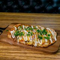 Colorado Pork Green Chili Flatbread · Pork Green Chili, Cheddar and Monterey Jack Cheeses, Grilled Red Onions, Sour Cream Swirl an...