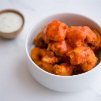 Signature Gluten-Free and Vegan Buffalo Cauliflower Wings · Our signature cauliflower wings tossed in our buffalo sauce with house-made vegan ranch dres...