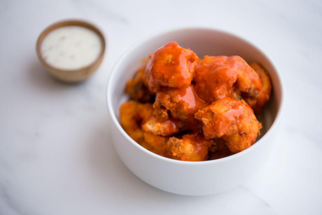 Signature Gluten-Free and Vegan Buffalo Cauliflower Wings · Our signature cauliflower wings tossed in our buffalo sauce with house-made vegan ranch dressing.