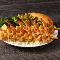 Shrimp Skewers Meal · Plump seasoned shrimp that are seared to perfection and served on a bed of rice.