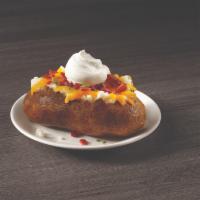 Loaded Baked Potato · A generous sized potato cooked to fluffy perfection and loaded with cheese, bacon and chives.