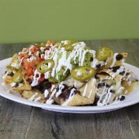 Benny’s Nachos · Tortilla chips topped with melted Jack cheese and your choice of black or pinto beans, serve...