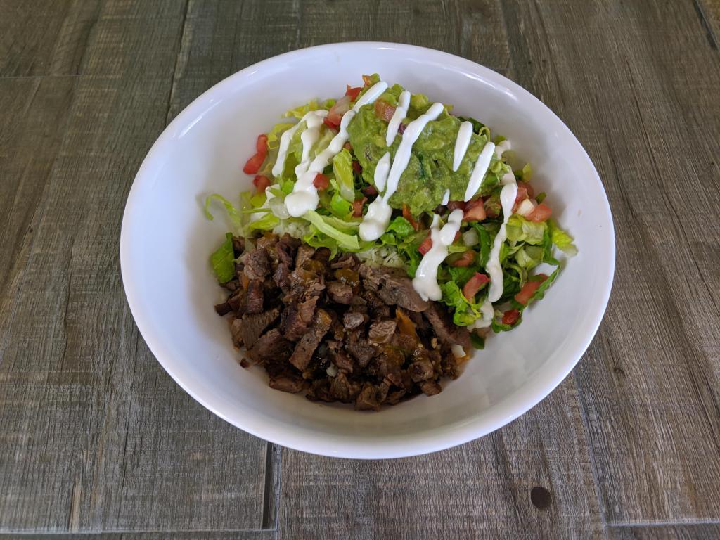 Carne Asada Burrito Bowl · Grilled marinated angus steak, rice, Jack cheese, salsa and lettuce choice of pinto or black beans served with sides of pico de gallo, guacamole and sour cream.