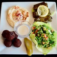 Mezza Sampler Platter · Chicken, .grape leaves, hummus and taboule. Served with pita bread.